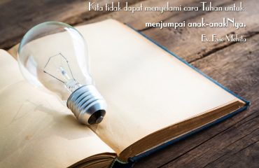 vintage book and light bulb on wood table