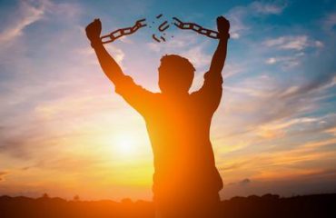 87173291-silhouette-image-of-a-businessman-with-broken-chains-in-sunset